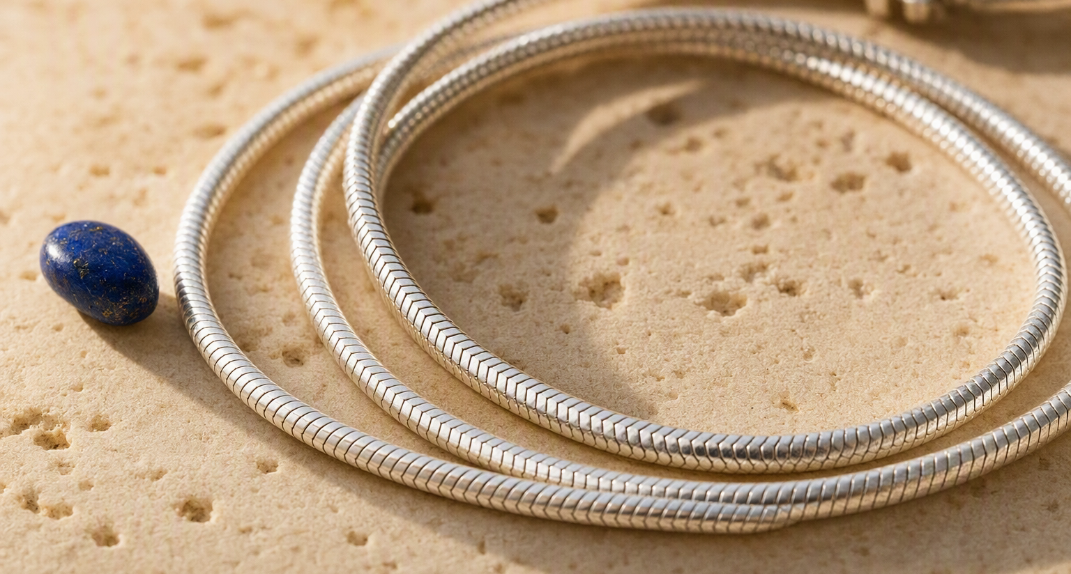 Sterling silver chain on travertine stone